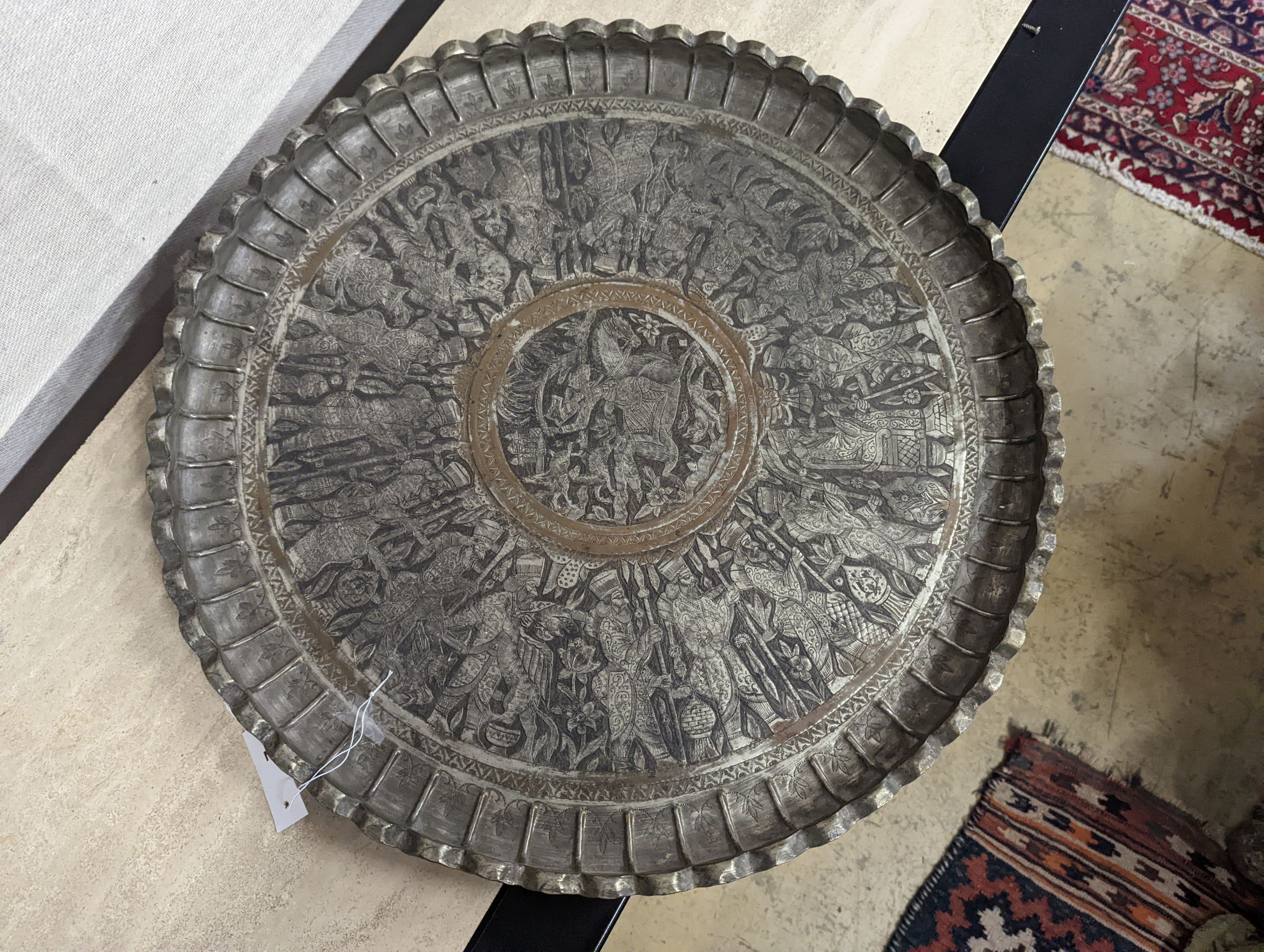 A Persian engraved circular tray, diameter 67cm